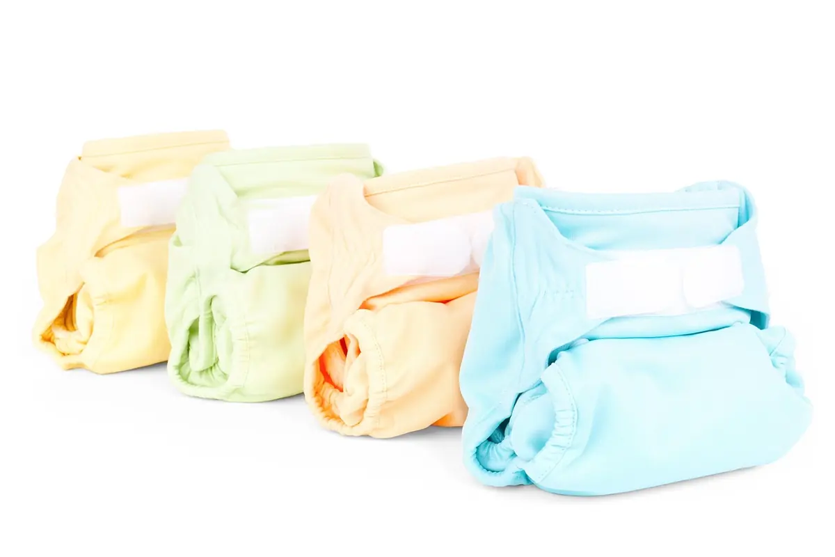 Four cloth diapers in yellow, green, orange and blue